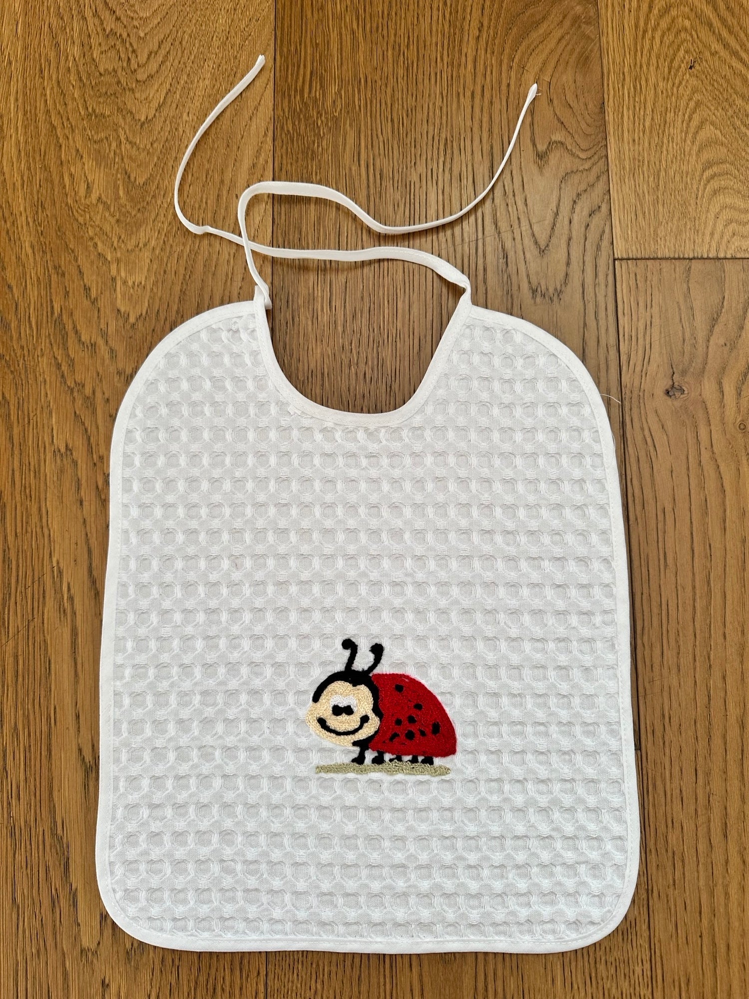 BIB WITH EMBROIDERY - LADYBIRD